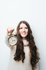 on a white background woman with an alarm clock in hands