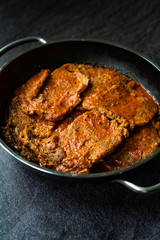 Homemade Slow Cooked Mexican Style Beef Meat with Tomato Paste Sauce in Pan.