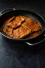 Homemade Slow Cooked Mexican Style Beef Meat with Tomato Paste Sauce in Pan.