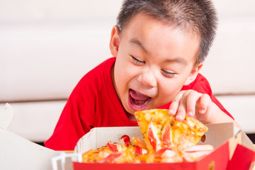 Little Child enjoying holding Delivery Pizza pepperoni, cheese