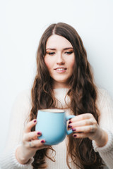 brunette girl drinking coffee or tea on a white background