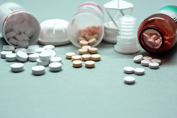 medical pills and tablets on table next to bottles