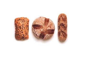 Different kinds of bread on white backdround. Top view, flat lay.