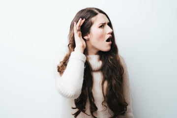 Fototapeta premium beautiful long-haired girl overhears on a white background