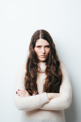 brunette girl is offended on a white background