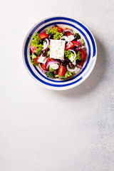 Fototapeta na wymiar Greek salad of fresh vegetables, olives and feta. Traditional Mediterranean food.