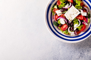 Greek salad of fresh vegetables, olives and feta. Traditional Mediterranean food.