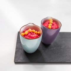 Pink Hummus with beet on yellow bright plate. Vegan healthy eating. op view, flat lay.