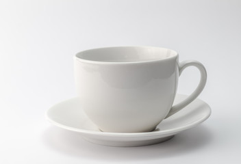 White cup and saucer isolated on white background