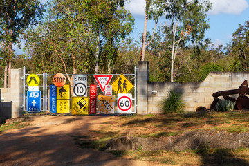 Random signs attached to a farm gate near Tinaroo Falls Dam in Queensland, Australia
