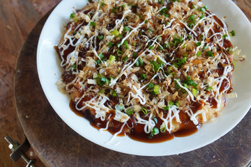 Okonomiyaki is a Japanese savory pancake containing a variety of ingredients in a wheat-flour-based batter