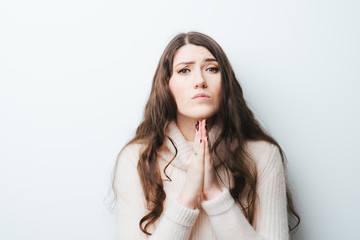 on a white background young girl with long hair praying