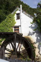 Polperro (England), UK - August 16, 2015: Tipycal house with a mill in Polperro village, Cornwall, England, United Kingdom.