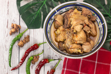 Spicy chicken meat dishes with chili on white wooden background