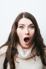 on a white background young girl with long hair is surprised