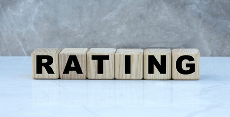 The concept of the word RATING on cubes on a gray background