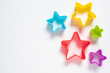 Star plastic Resting on a white background. Multicolored star plastic. Cookie cutter star shape on white background.