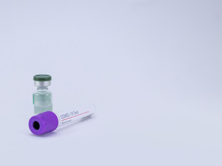 An empty blood sample tube for Coronavirus test with a vial containing transparent injectable liquid  .