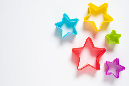 Star plastic Resting on a white background. Multicolored star plastic. Cookie cutter star shape on white background.