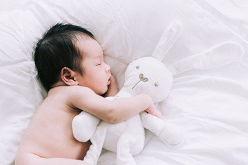 Smiling baby boy lying on a white bed, Family morning at home,Children hygiene.