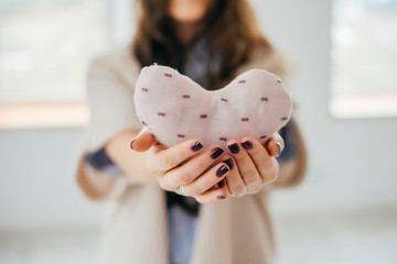 hands holding a soft heart shape