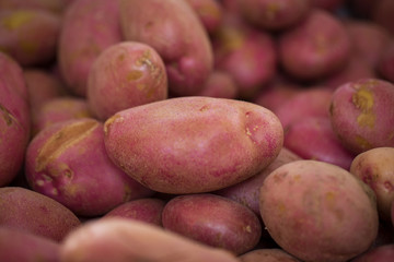 Potatoes close up, top view. Potato background. Pink grade of potatoes.