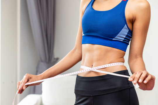 Attractive female woman torso with measuring tape, weight loss and dieting concept