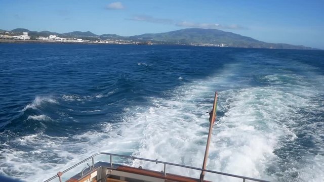 Portuguese Waving Flag in the stern of a ship. View from a boart