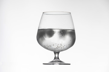Glass cup with drink and ice