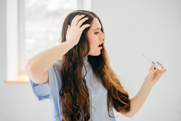 Young woman checking temperature close up shoot