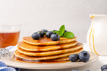 Stack of pancakes with fresh blueberry and caramel syrup