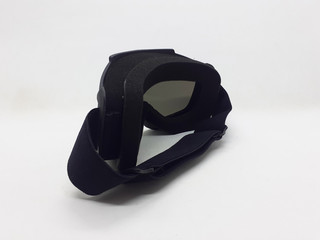 Fototapeta premium Dark Colored Plastic Modern Goggles for Eye Protection in Motorbike Sport and Paintball Games in White Isolated Background 