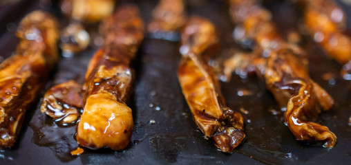 Lamb strips marinated with oyster and soy sauce In an oven tray. Selective focus.