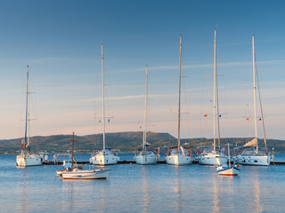 Fototapeta premium Milos island/Greece-05-06-2019: Group of yacht in marine in morning light