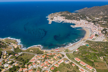 Fototapeta premium Aerial drone photo of a coastal city in Spain on a beautiful sunny day with a beautiful blue sea