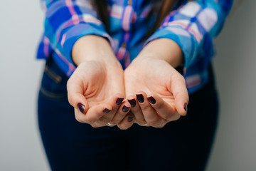 Fototapeta premium The open hands of woman. Your objects here. Hands cupped together against white