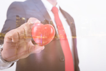 Double exposure of businessman  Hold heart  and city night background