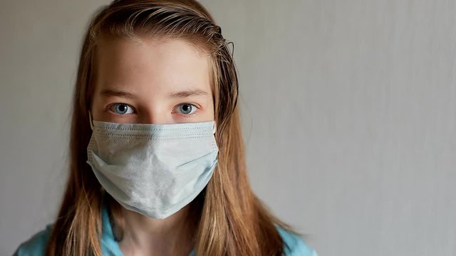 self-isolation and quarantine, portrait of a teenage girl in a medical mask, protection from viruses and diseases