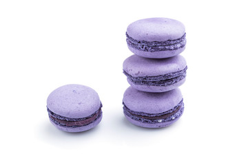 Purple macarons or macaroons cakes isolated on white background. Side view.