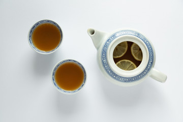 Tea time with rice china tea set - white kettle, cups, tea leaves, lemon