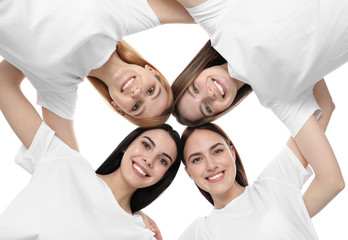 Beautiful young ladies hugging on white background, bottom view. Women's Day