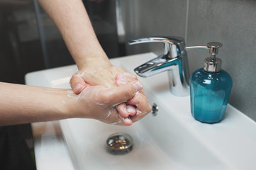 Man is washing hands with soap. Coronavirus Covid-19 prevention. Сorona virus pandemic.