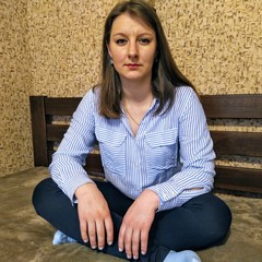 Envy european woman sit on bed at home