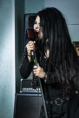 Rock star singing into a microphone in the recording studio ..