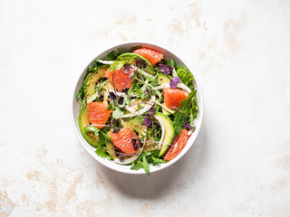 Grapefruit and fennel salad in white bowl. Top view . Copy space