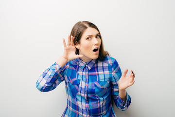 Closeup of emotional shocked woman surprised girl with hand to ear listening secret gossip or quiet...