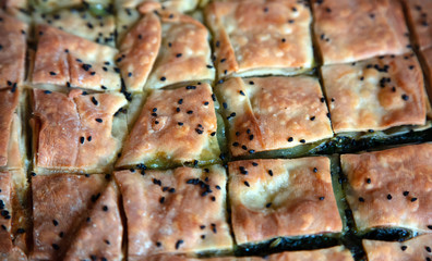 .Spinach pie, greek spanakopita with phyllo background.