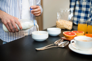 Cereal cornflake with milk it is the best breakfast. Family couple eating healthy food