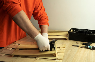 A man works as a stapler with a tree