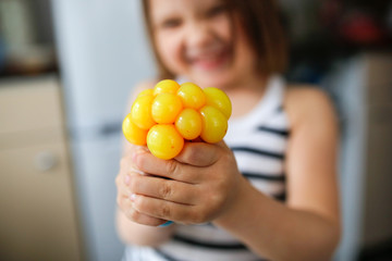 child squeezes yellow slime, modern children toys